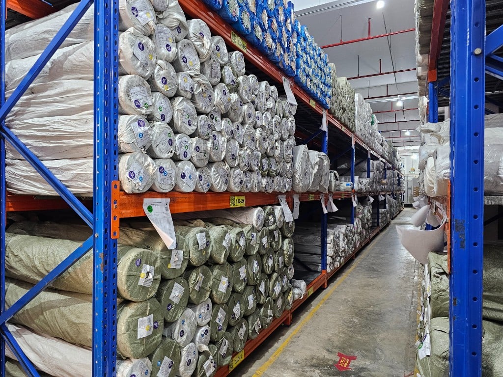 Fabric warehouse with QR-tracked inventory — Bangladesh workwear sourcing