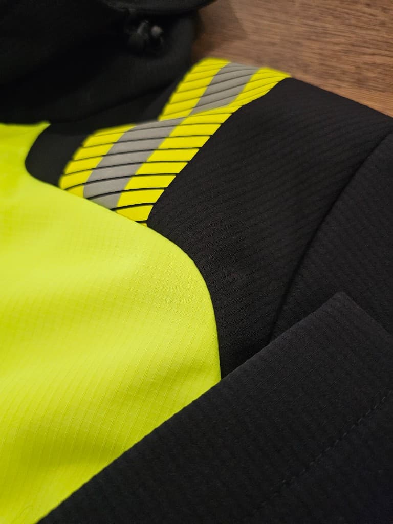 Hi-vis jacket construction with reflective tape placement detail