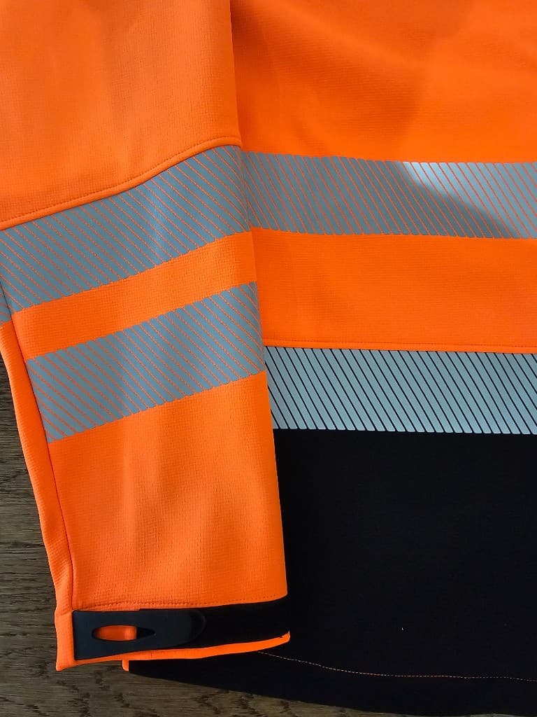 Hi-vis garment with segmented reflective tape on sleeve and cuff