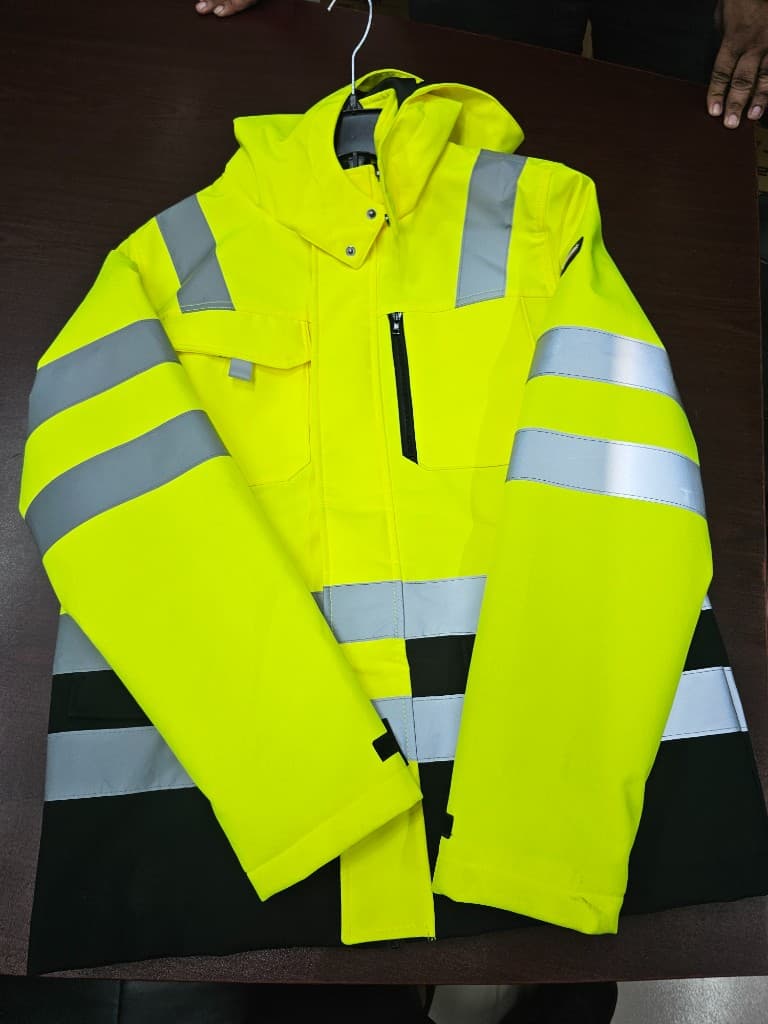 Two-tone hi-vis insulated safety jacket laid flat for specification review