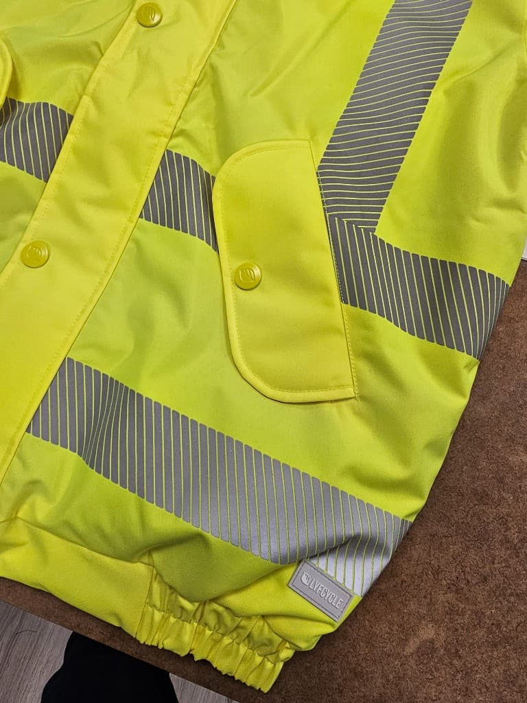 Two-tone hi-vis hooded safety jacket on showroom rail