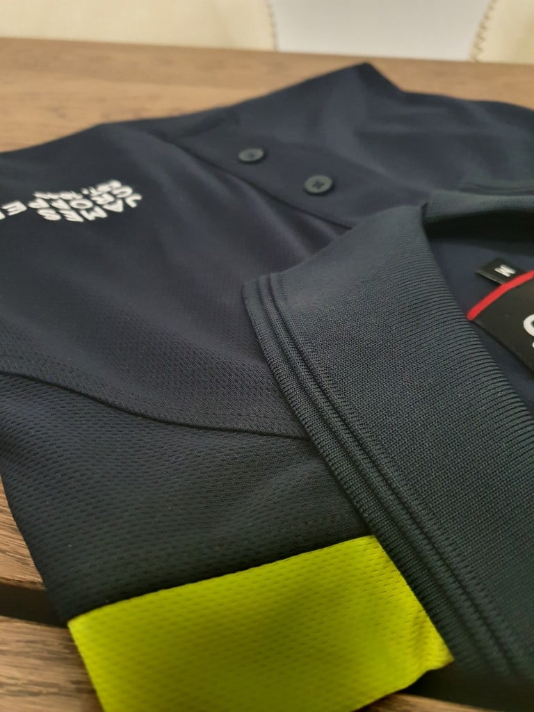 Corporate workwear polo collar and fabric detail for uniform programmes